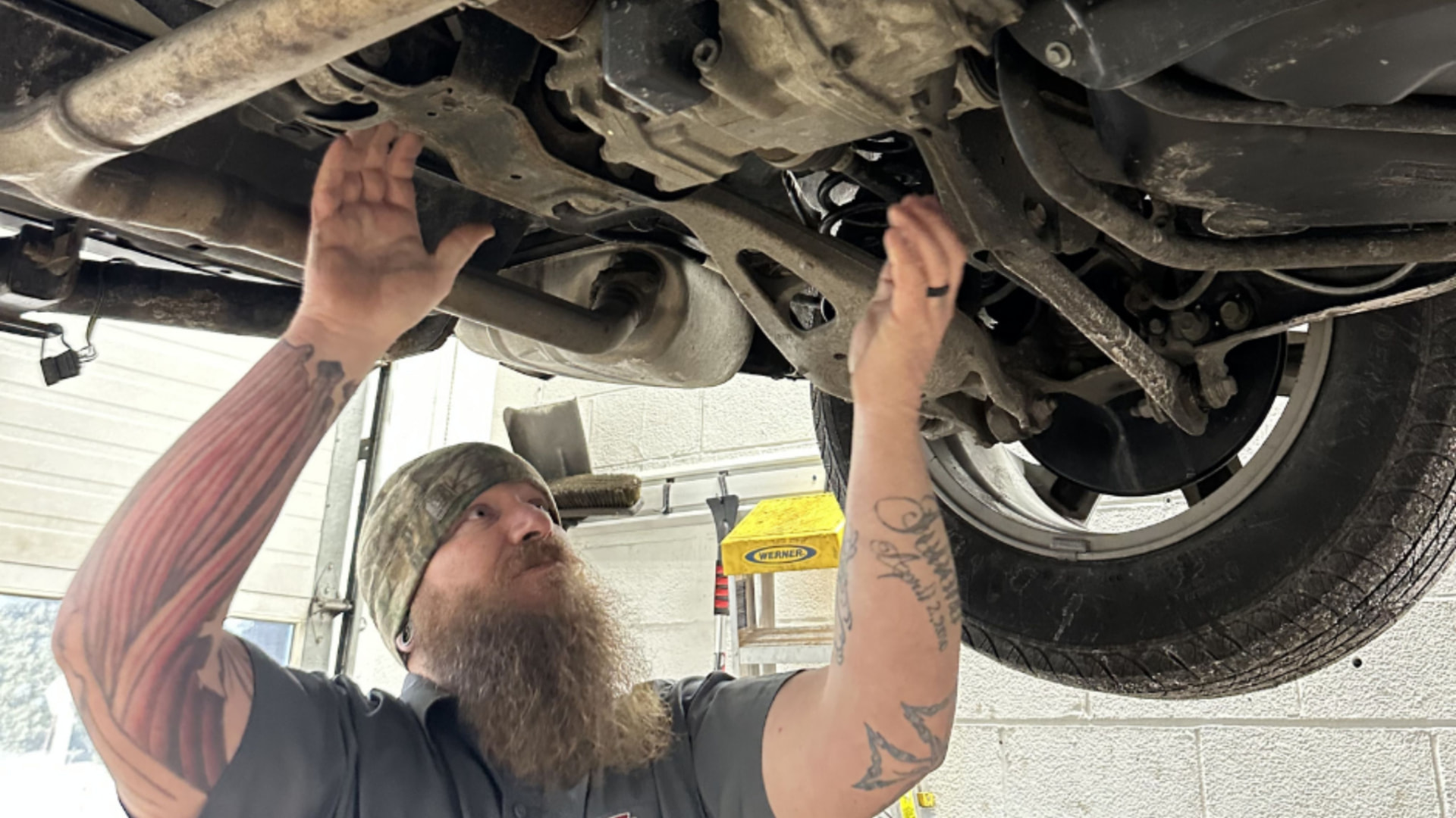 Keystone Automotive Repair service bay with a vehicle on the lift